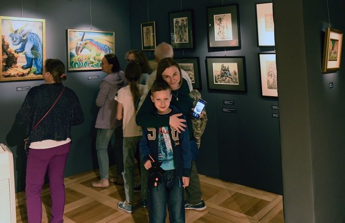 Turyści oglądają wystawę obrazów.